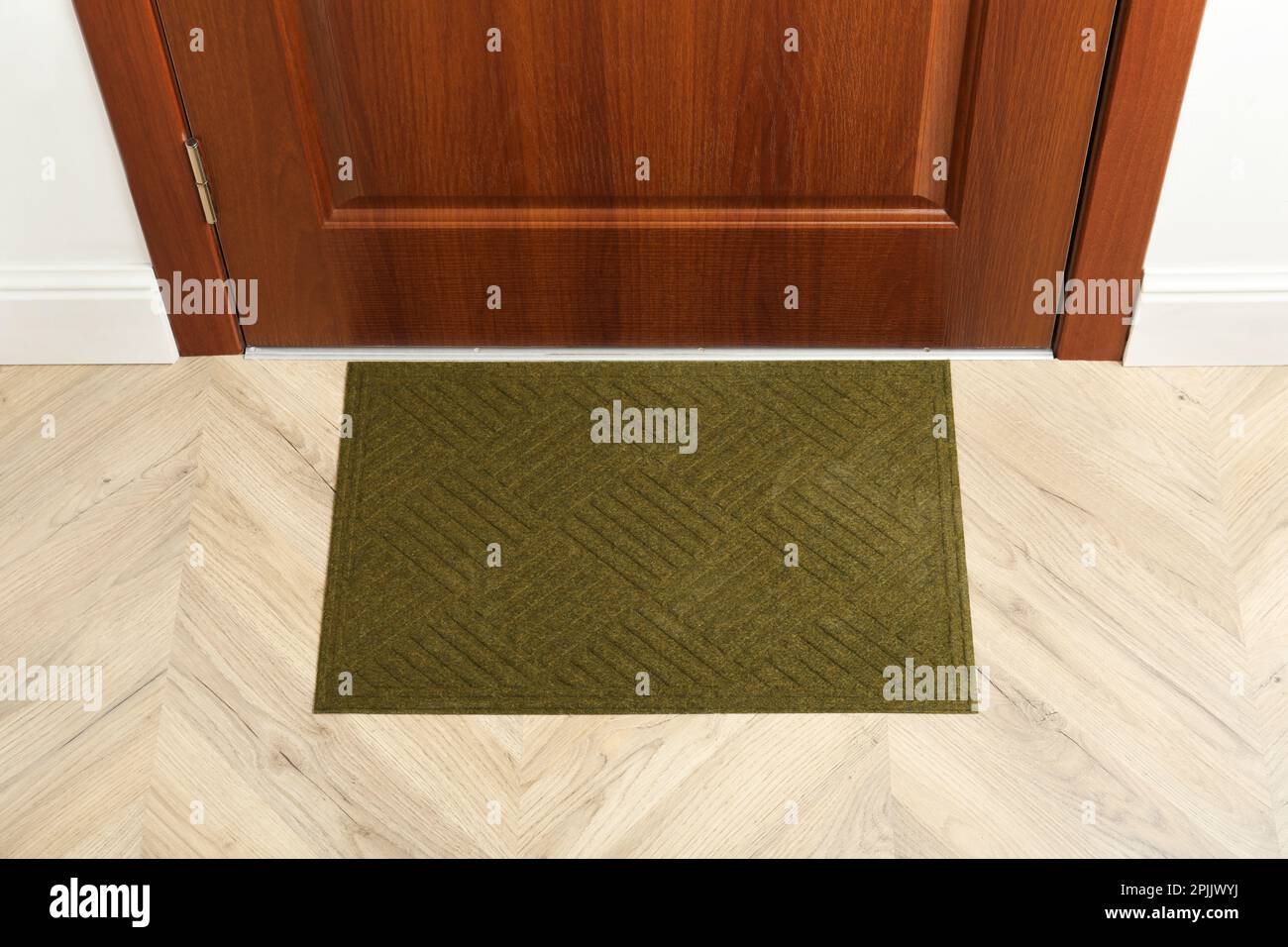 New clean green mat near entrance door Stock Photo Alamy