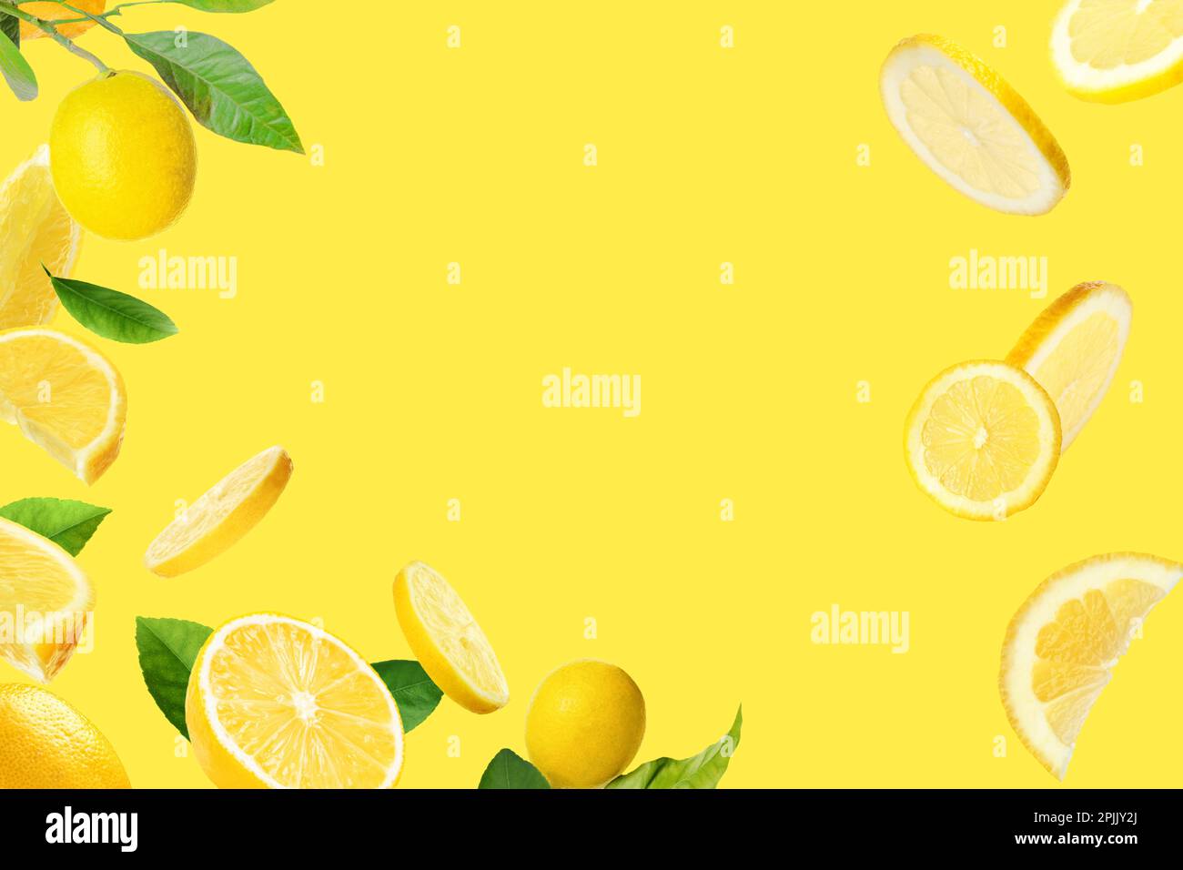 Fresh ripe lemons and green leaves on yellow background. Space for text Stock Photo