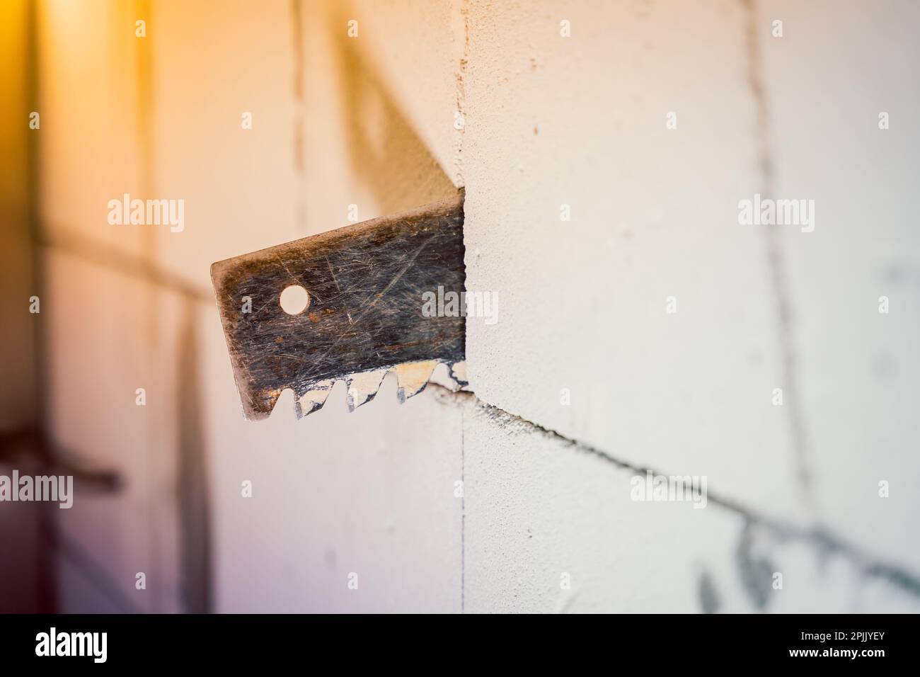 The process of cutting through a wall from an aerated concrete block ...
