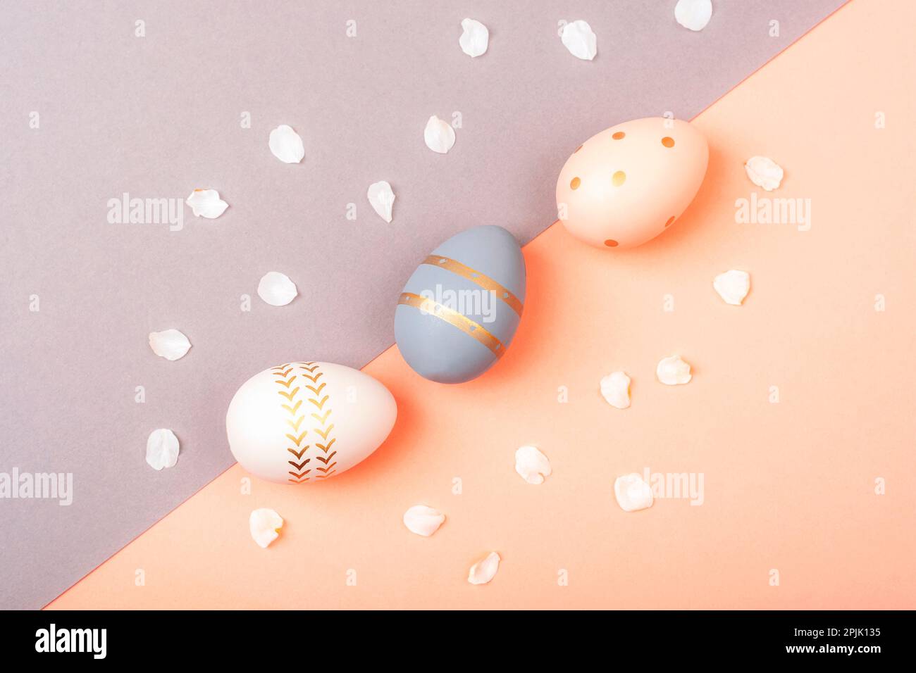 Colorful Easter eggs on pink and gray background. Top view, flat lay. Stock Photo