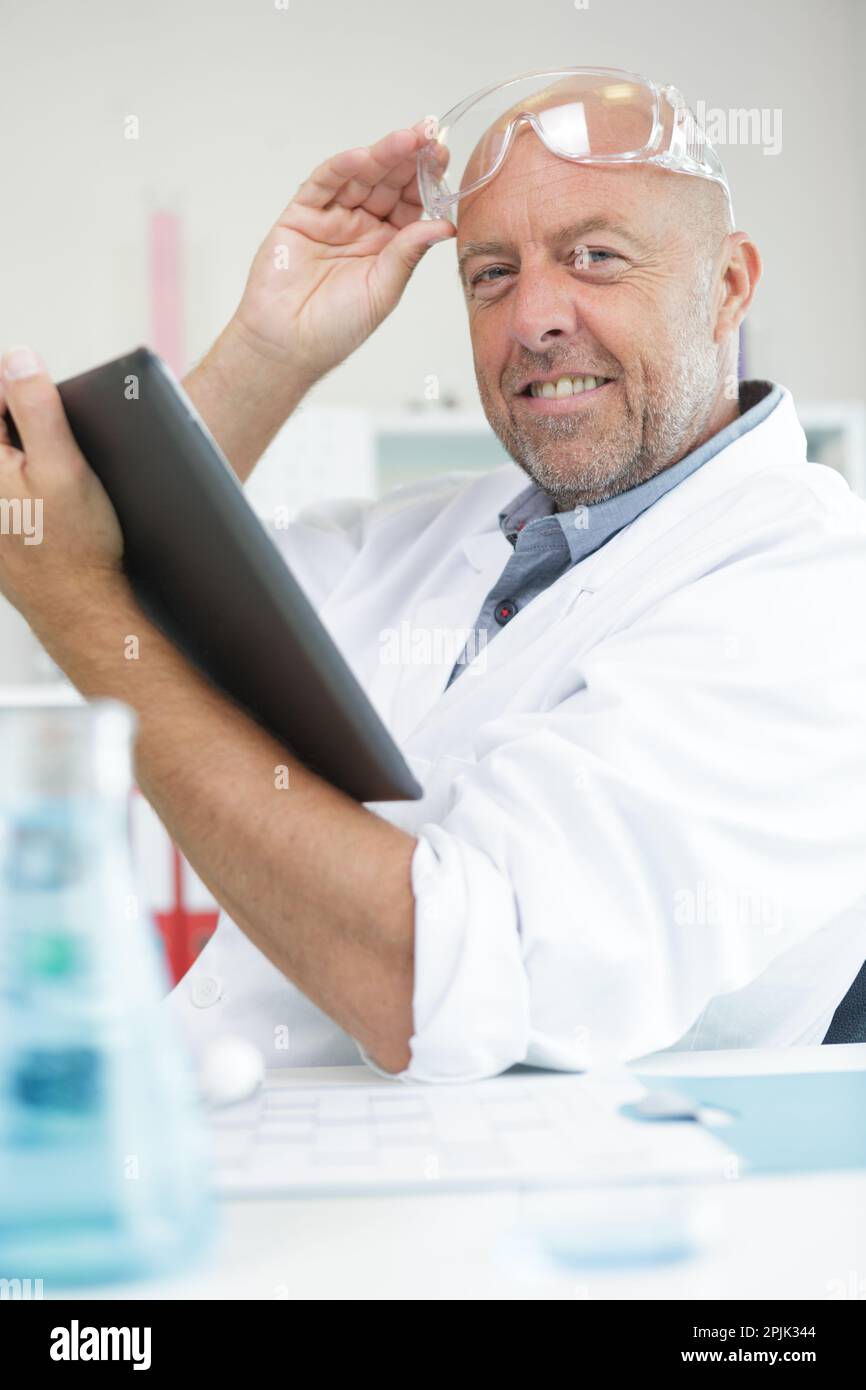 senior scientist holding a tablet pc Stock Photo