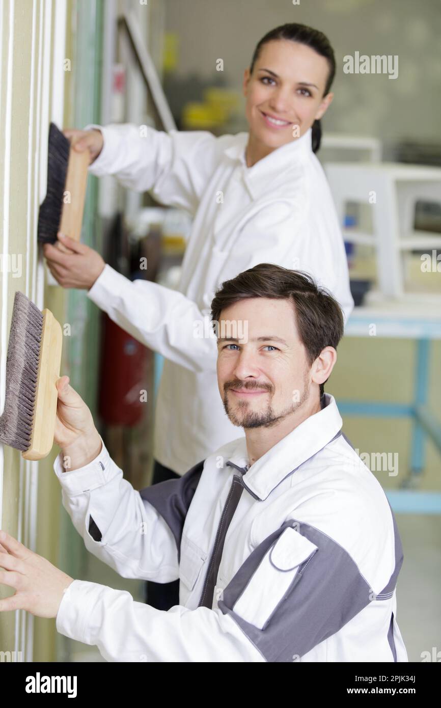 woman painter painting a wall with paint working hard Stock Photo Alamy