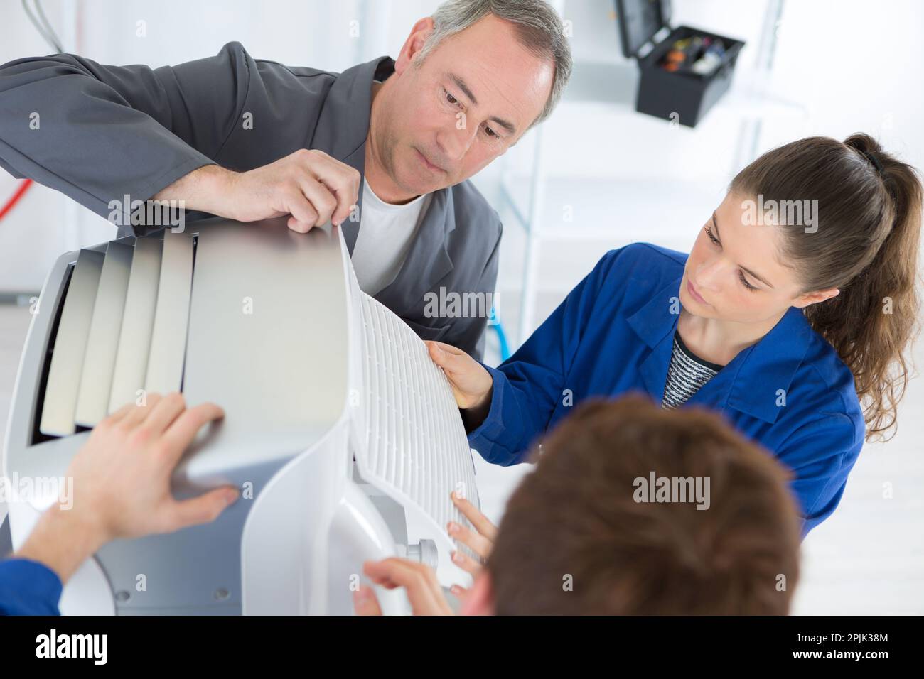 the apprentices and technician inspecting aircondition Stock Photo