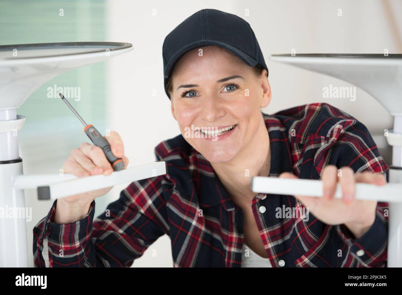 female worker is fixing a chair Stock Photo - Alamy
