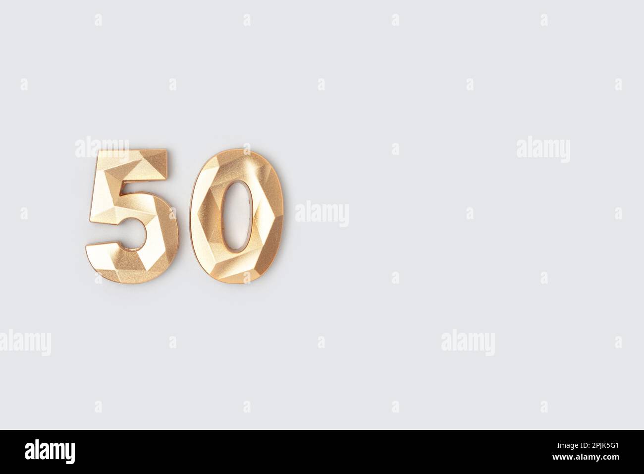 Golden number fifty on a blue background. Minimal concept. Stock Photo
