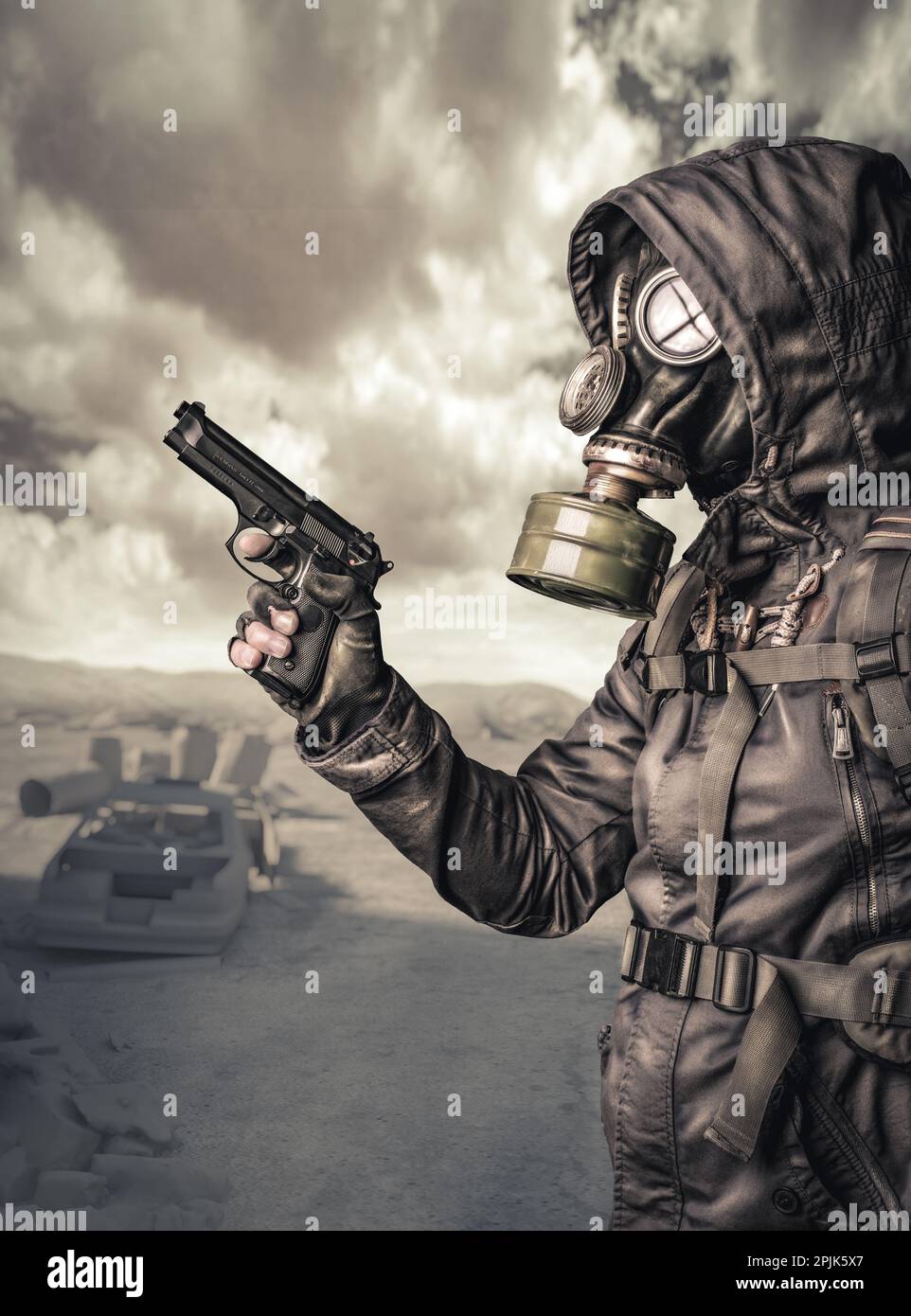 armed man with gas mask in a post-apocalyptic situation Stock Photo