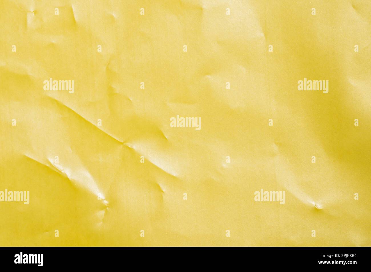 an empty wrinkled yellow gold pearl tissue paper textured background