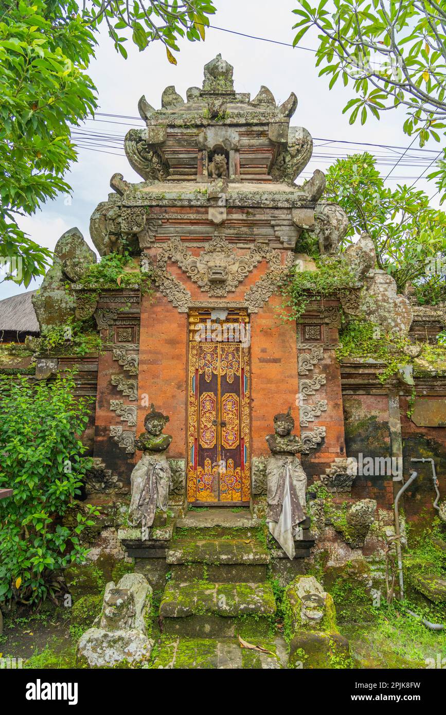 Wooden gates from a house. Traditional Balinese house gates with natural stone, carved wood at Ubud Stock Photo