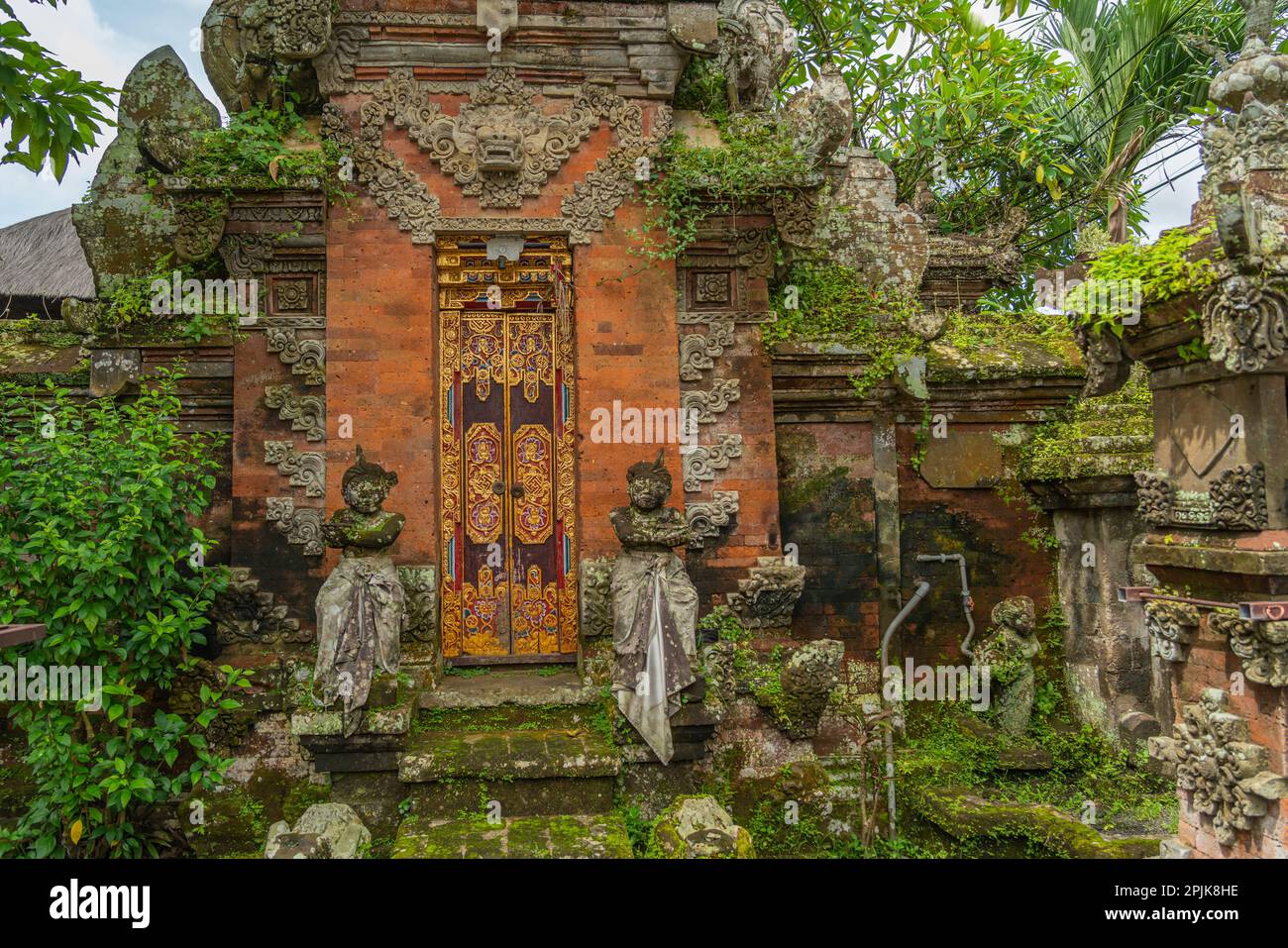 Wooden gates from a house. Traditional Balinese house gates with natural stone, carved wood at Ubud Stock Photo