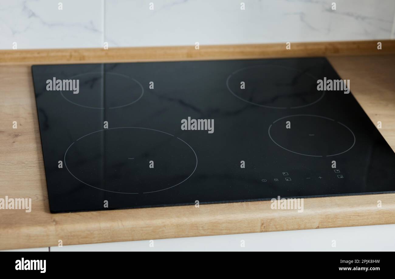 New electric stove with induction cooktop in kitchen. induction ceramic