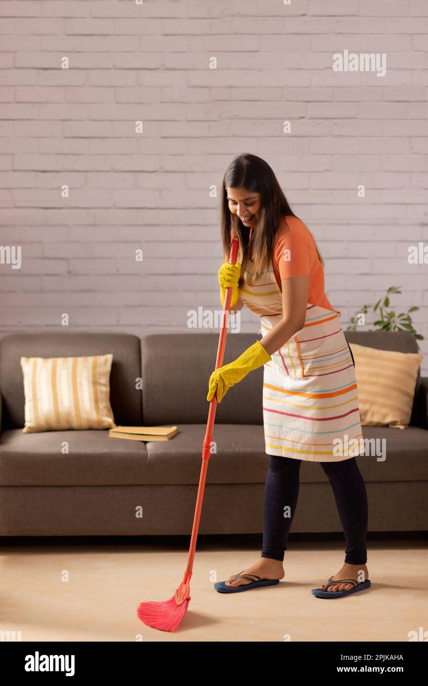 Portrait of woman sweeping floor with a broom at home Stock Photo Alamy