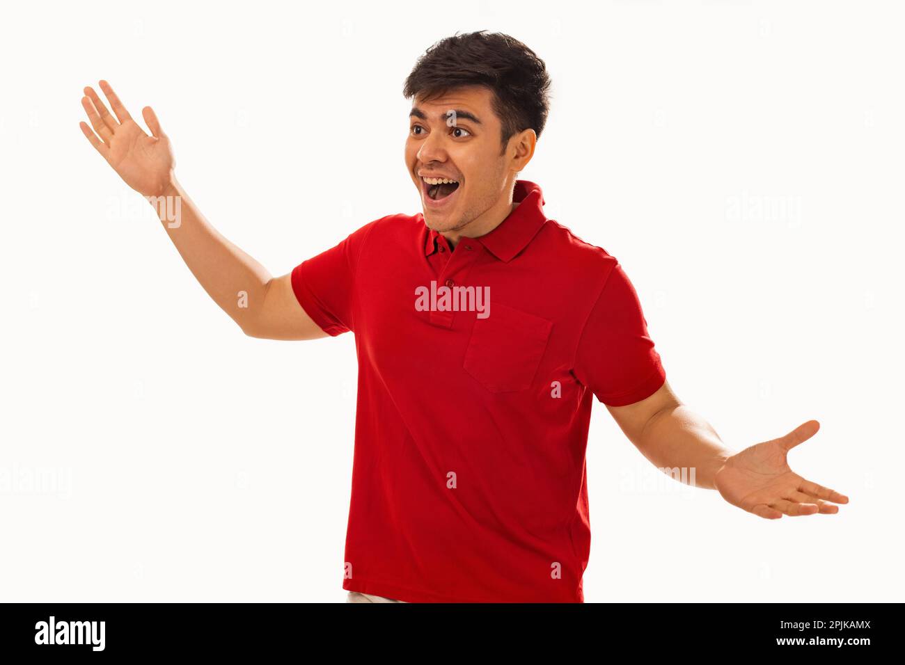 Portrait of an excited young man gesturing against white background Stock Photo