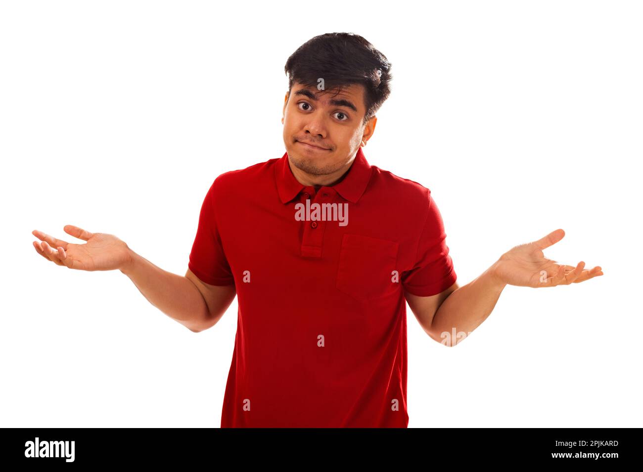 Portrait of young man shrugging against white background Stock Photo