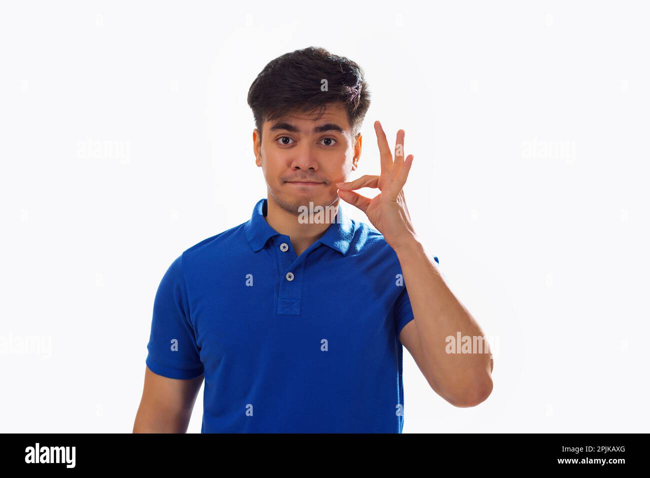 Portrait of young man gesturing against white background Stock Photo
