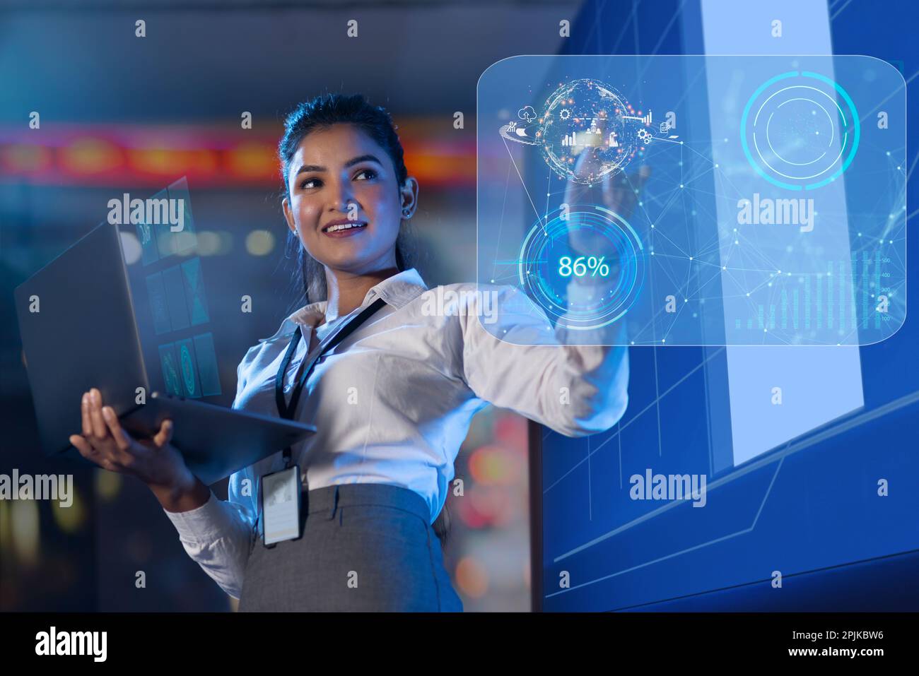 Businesswoman using laptop touching on virtual screen Stock Photo