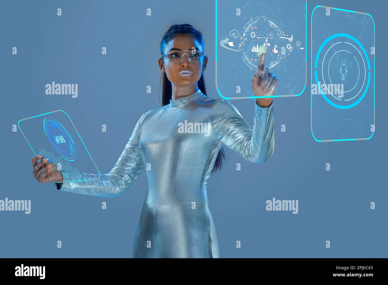 A model dressed as a robot wearing silver, futuristic clothes holding a ...