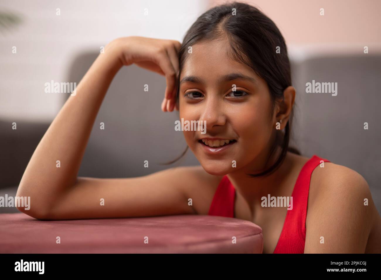Close-up portrait of a cheerful girl looking at camera Stock Photo