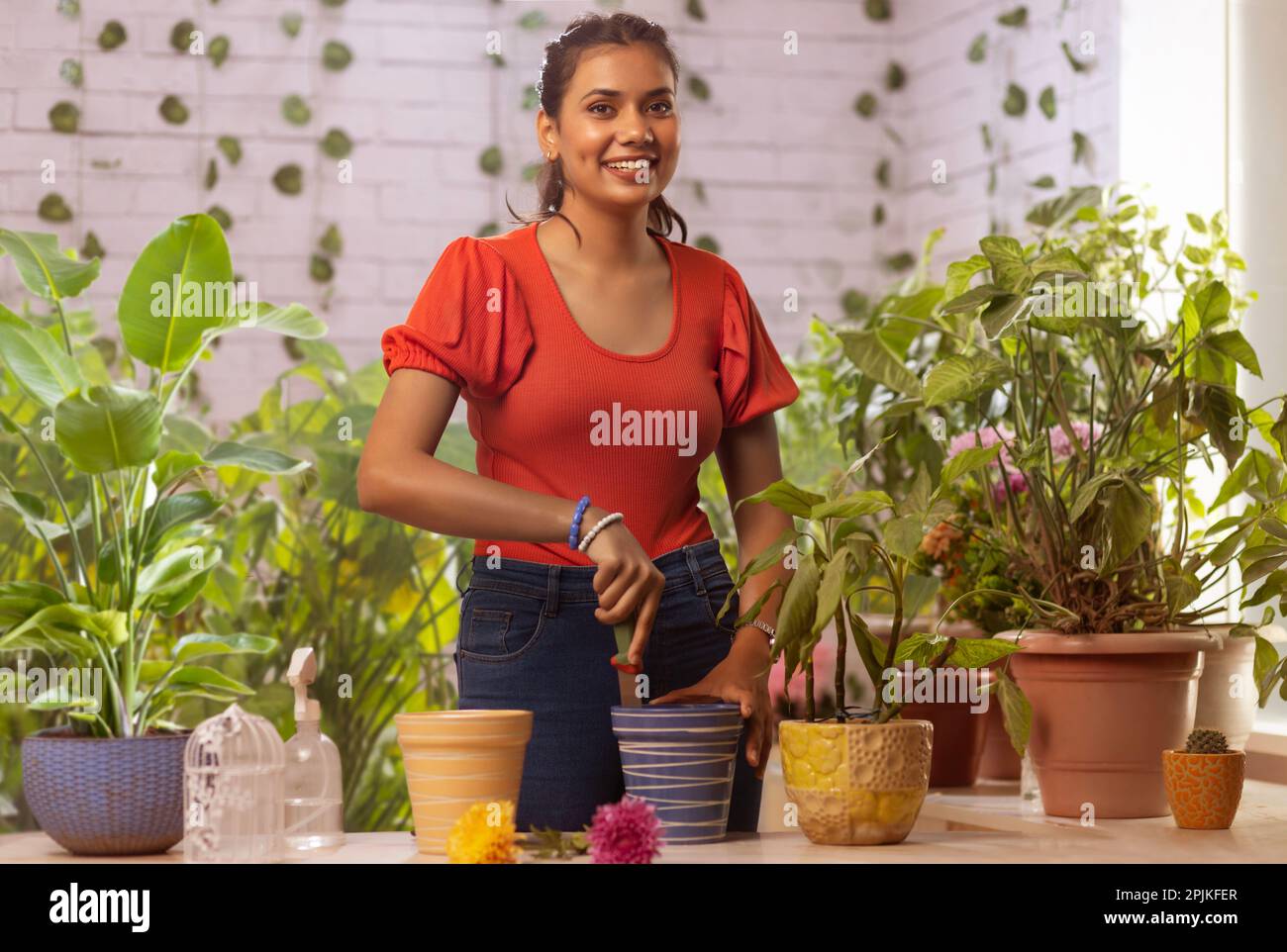 Young woman gardening at home Stock Photo