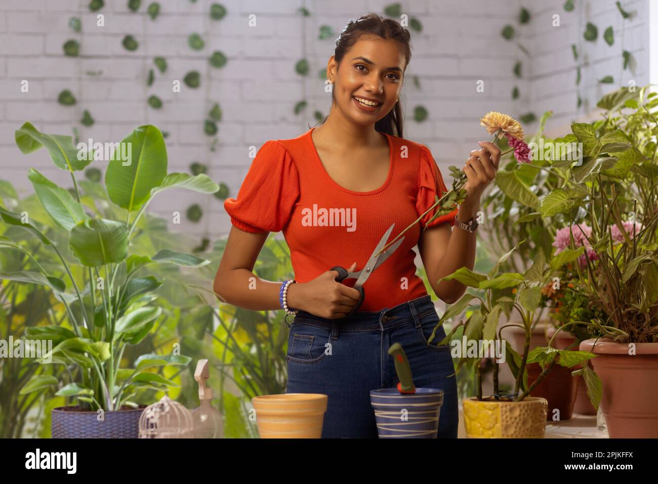 Portrait of young woman gardening at home Stock Photo