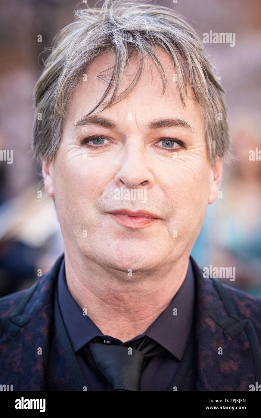 Julian Clary poses for photographers upon arrival at the Olivier Awards