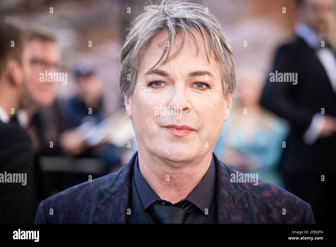 Julian Clary poses for photographers upon arrival at the Olivier Awards