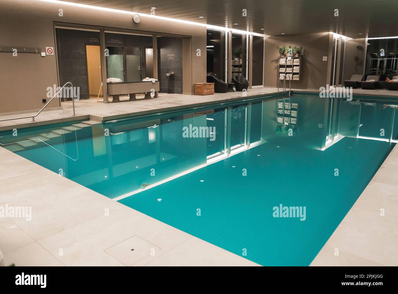 Interior of the illuminated luxury hotel with swimming pool and decor ...