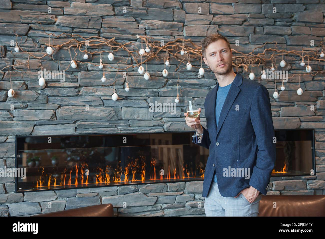 Man with wineglass standing at luxury hotel during vacation Stock Photo