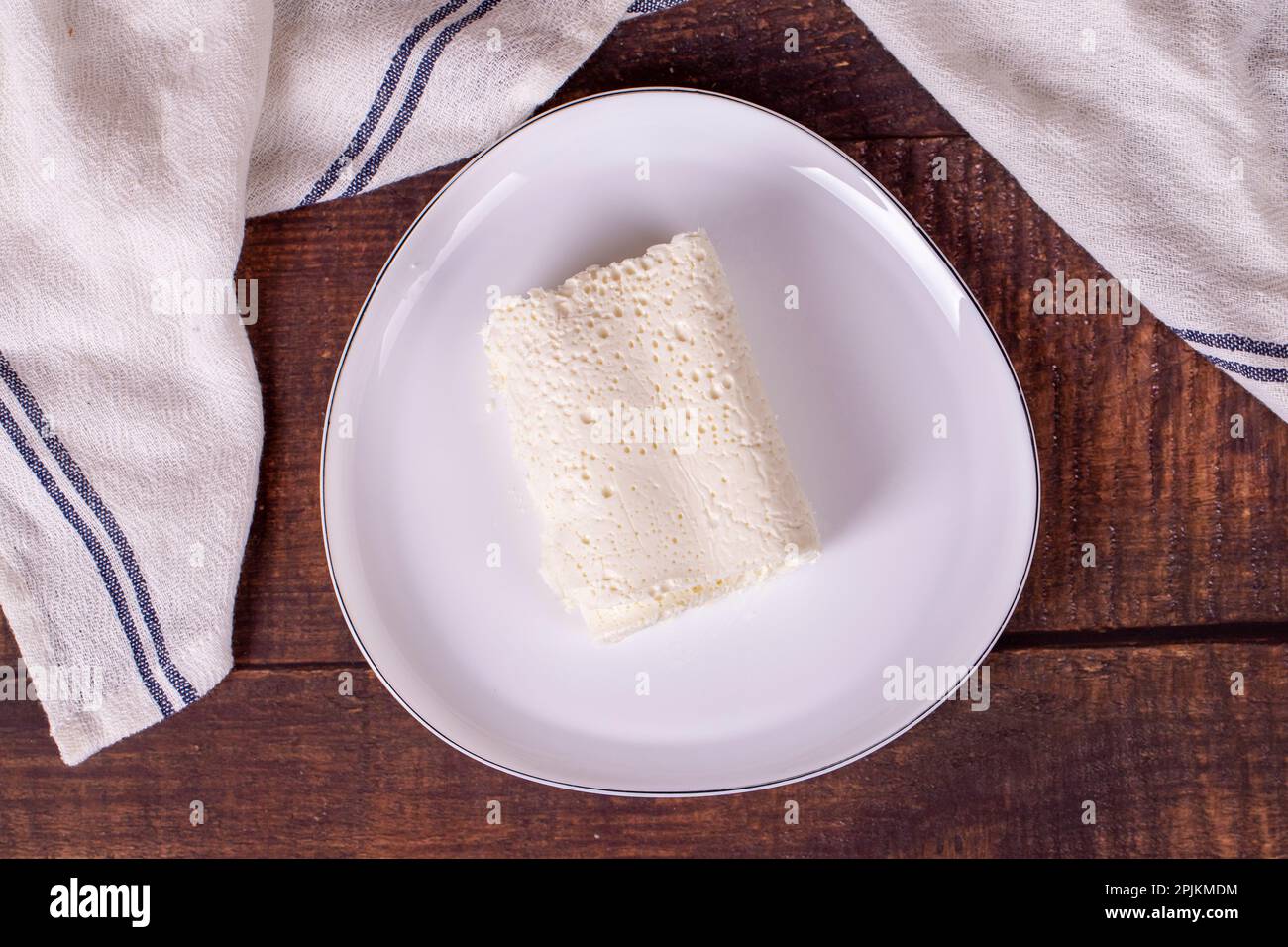 Clotted cream on wood background. Clotted cream (butter cream) for Turkish breakfast. local name inek kaymak. Top view Stock Photo