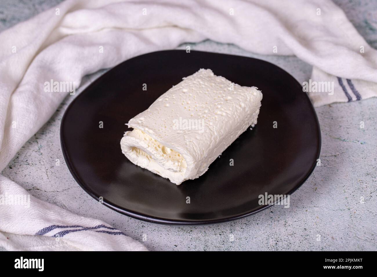 Clotted cream on gray background. Clotted cream (butter cream) for Turkish breakfast. local name inek kaymak Stock Photo