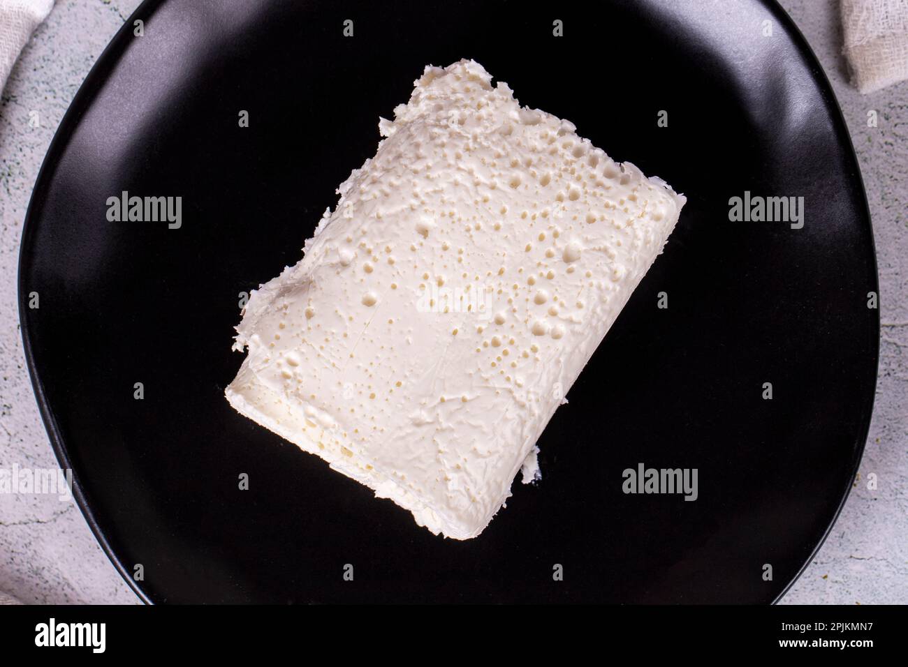 Clotted cream on gray background. Clotted cream (butter cream) for Turkish breakfast. local name inek kaymak. Top view Stock Photo