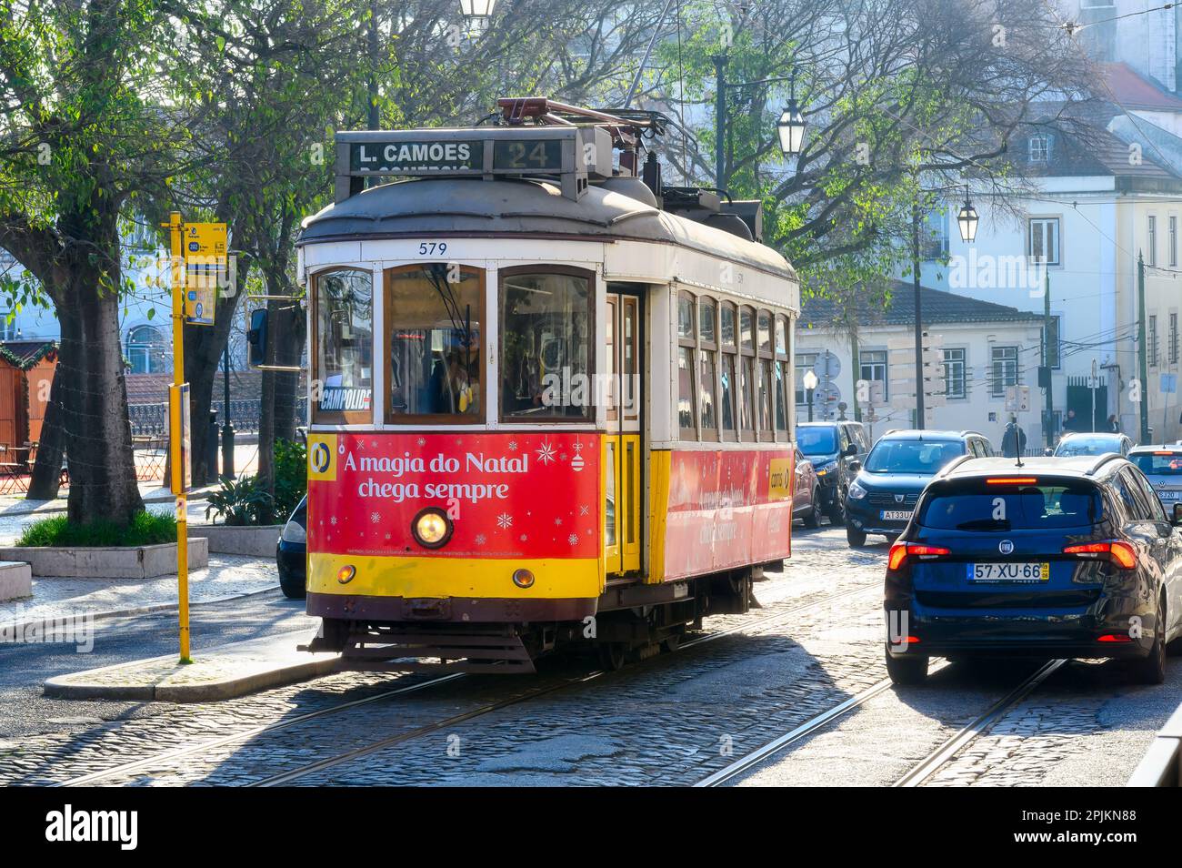 Lisbon, Portugal January 4, 2023 Red streetcar moving through an old
