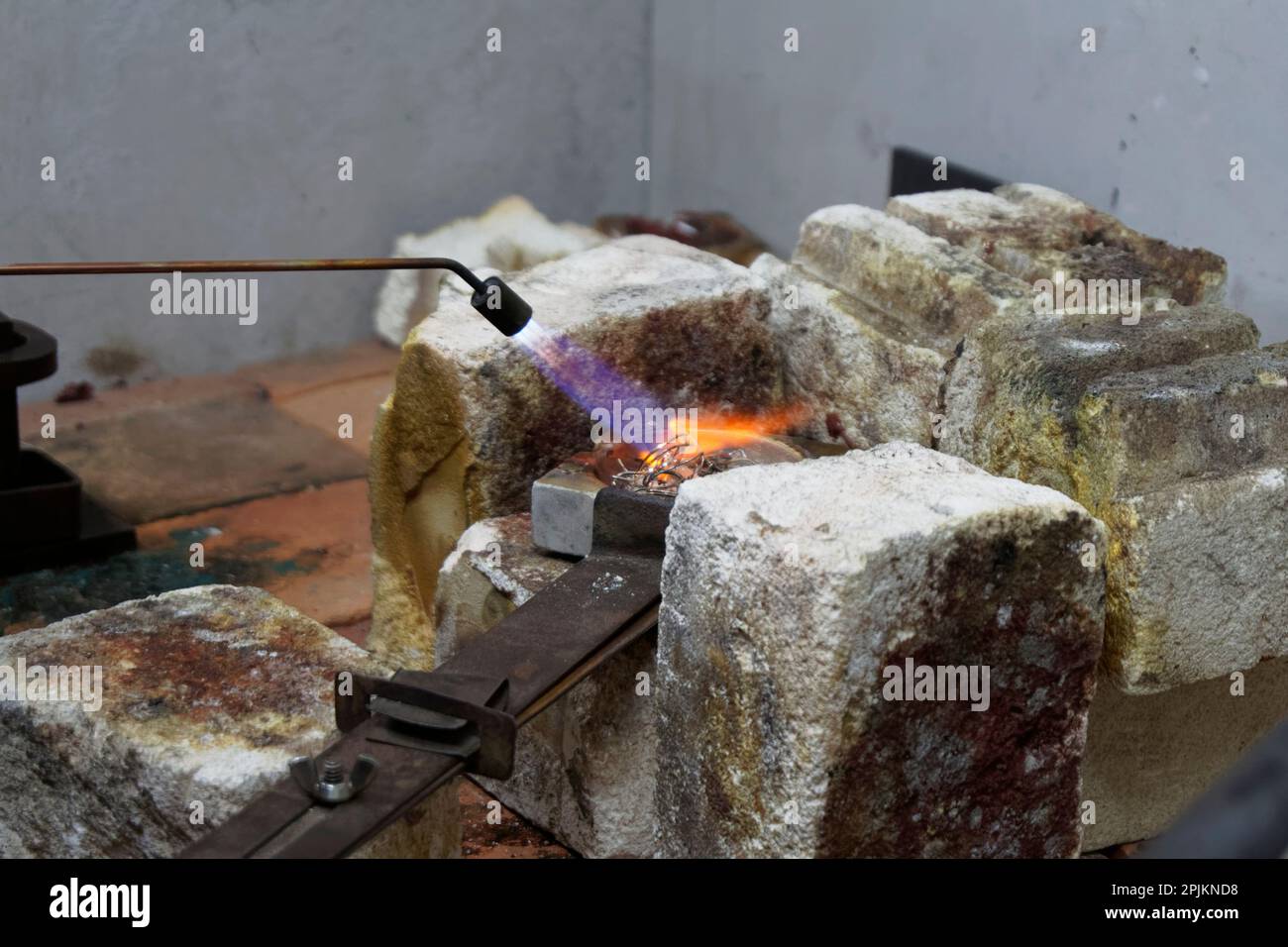 Heat is applied to unused silver from a blow torch, it is going to be melted down and used again