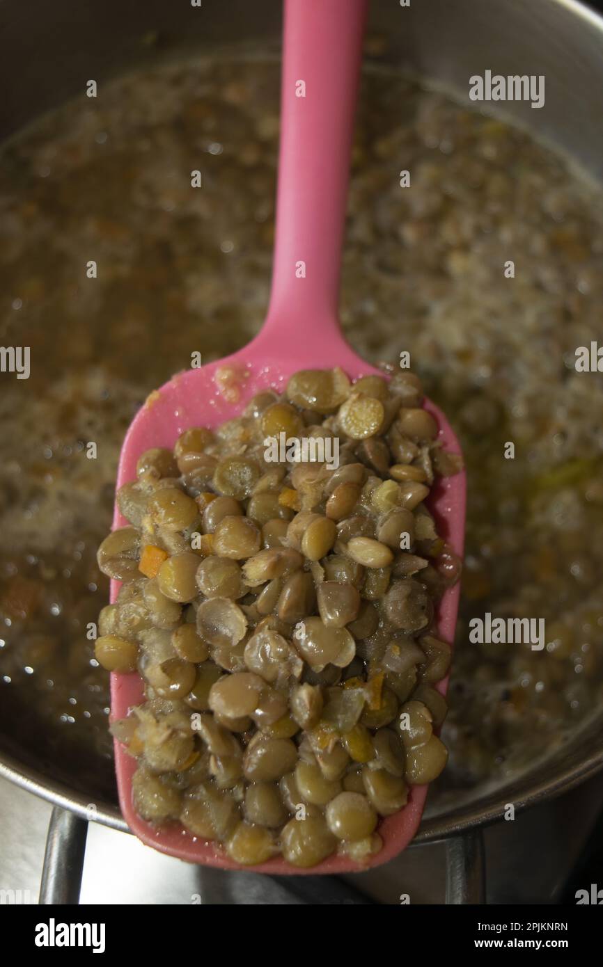 detail of a ladle of lentils taken from a soup Stock Photo