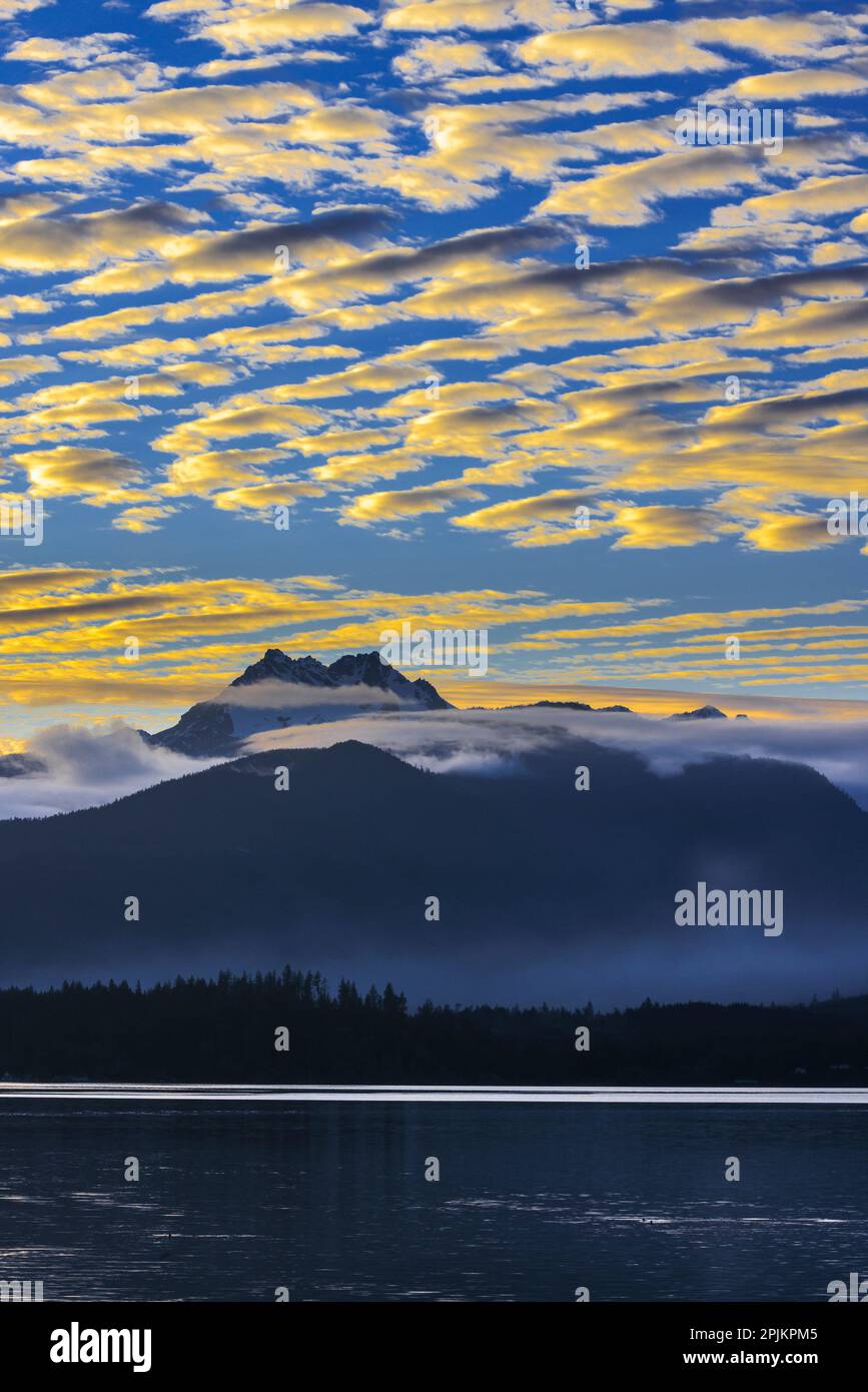 USA, Washington State, Seabeck. Sunset over Olympic Mountains and Hood ...