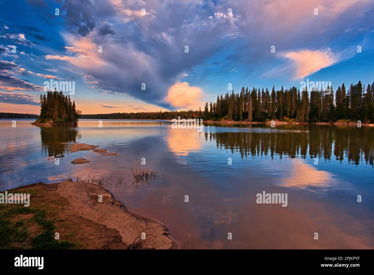 Canada, Manitoba, Paint Lake Provincial Park. Island on Paint Lake at sunrise. Stock Photo