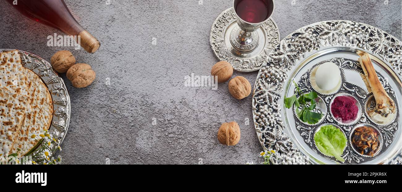 Passover Seder plate with traditional food, walnuts, matza and wine on ...