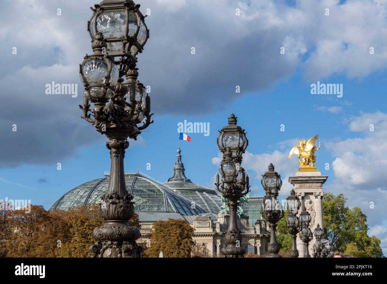 Paris. Decorative street lamp on Pont Alexandre III, along River Seine. Grand Palais in background. Stock Photo