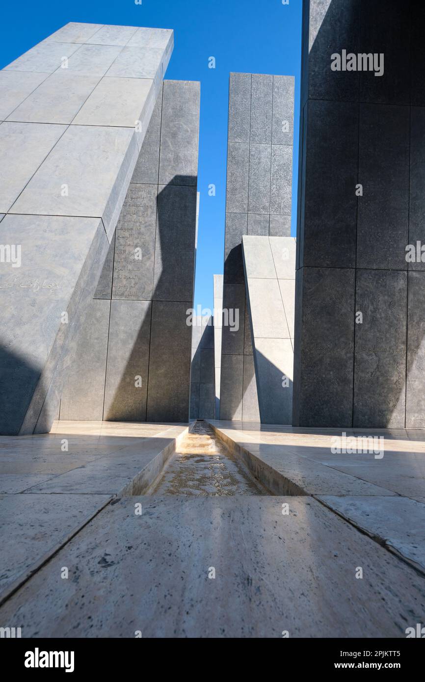 The grey, triangle shape of the artwork. At the Wahat Al Karama ...