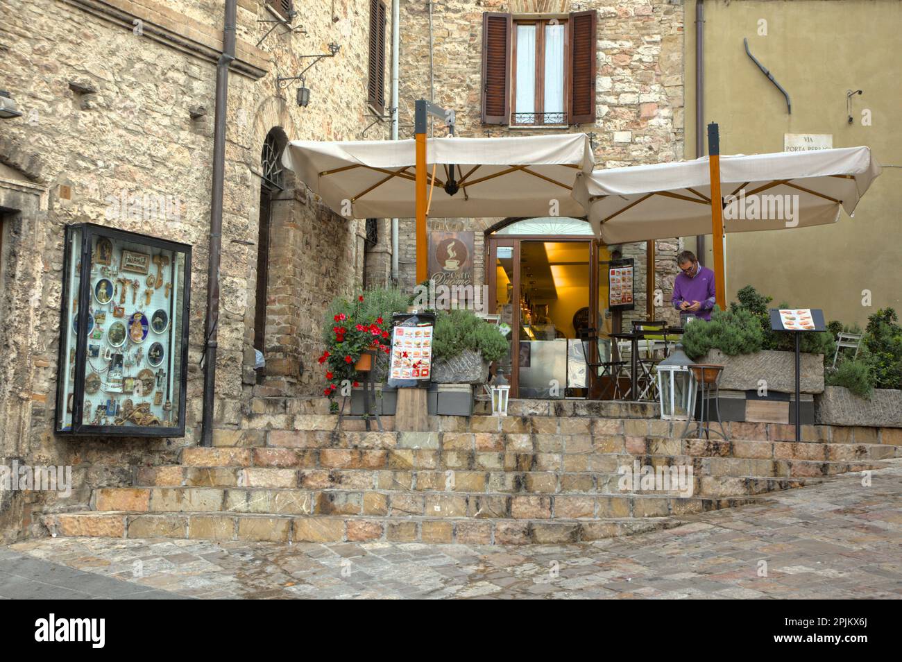 Italy, Umbria. Restaurant with outdoor seating in the town of Assisi ...