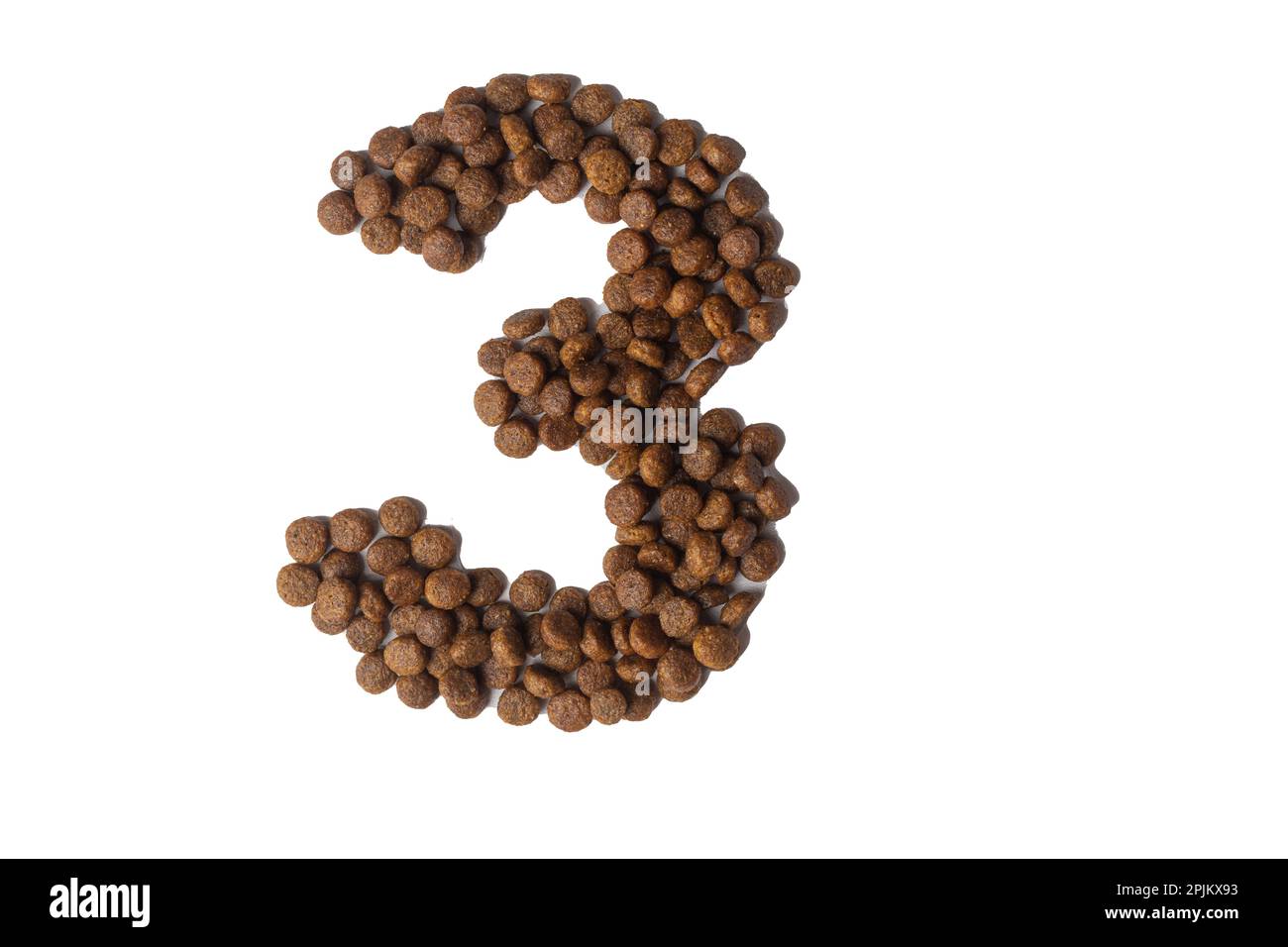 Number 3 made from dry pet food on a white background. Design, layout. Dietary therapeutic nutrition for dogs and cats. Favorite food for animals. Car Stock Photo