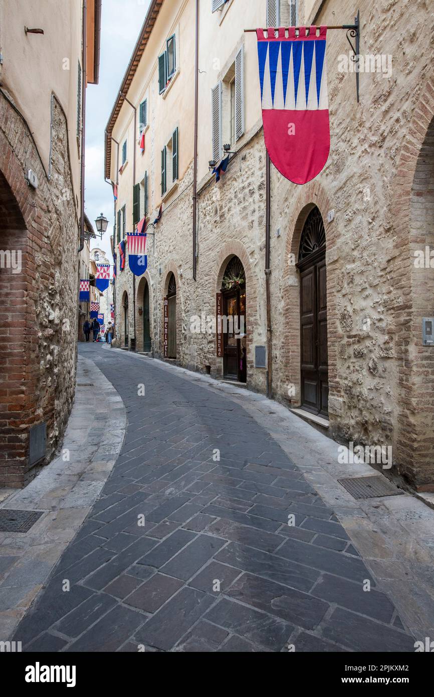 Italy, Umbria. Streets in the historic district of San Gemini decked out with festival jousting flags. Stock Photo
