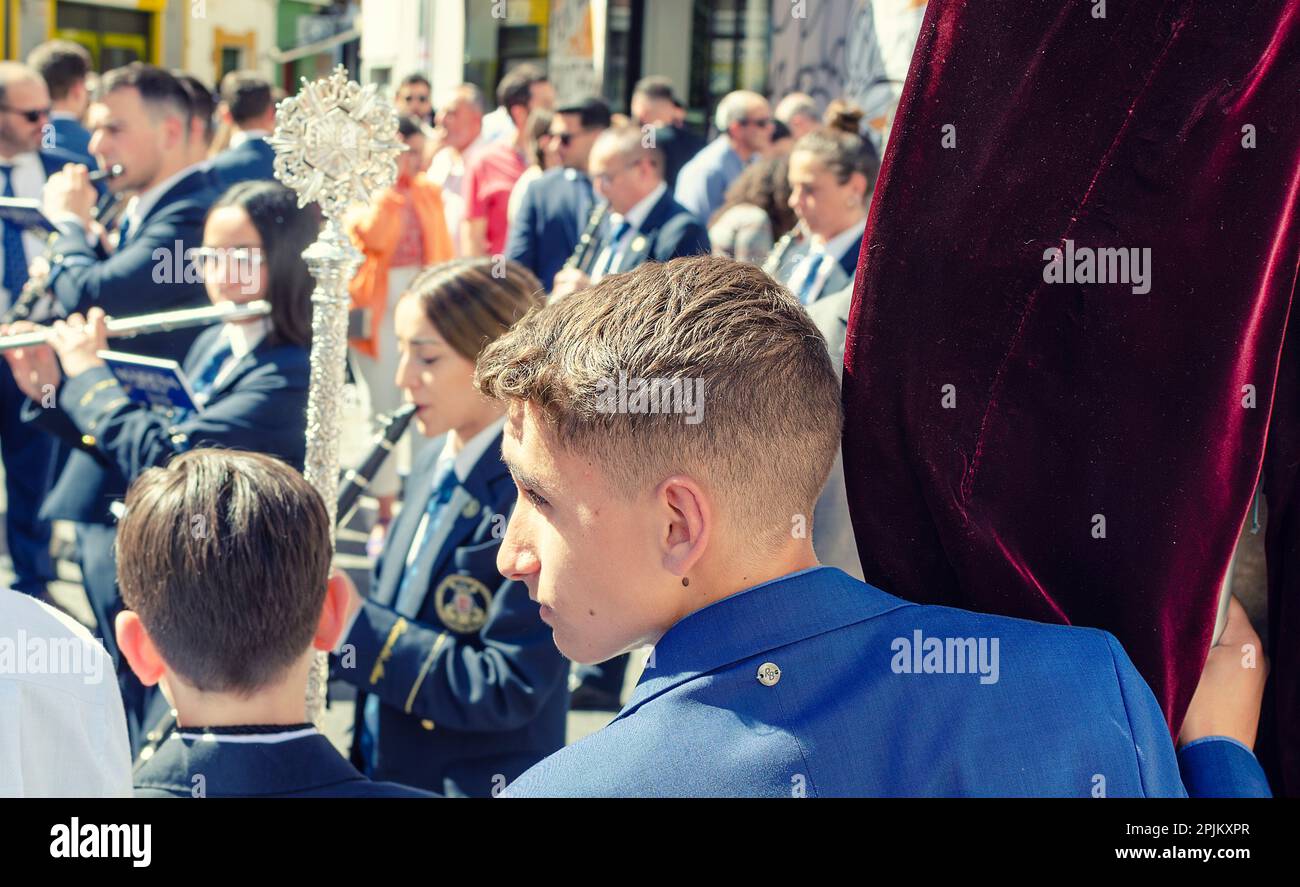 Seville, Spain; April 2, 2023: Young boy of Hiniesta Brotherhood during the processions of Holy Week. Palm Sunday. Stock Photo