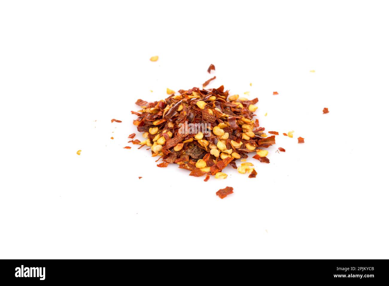 The pile of a crushed red pepper, dried chili flakes and seeds isolated on white background