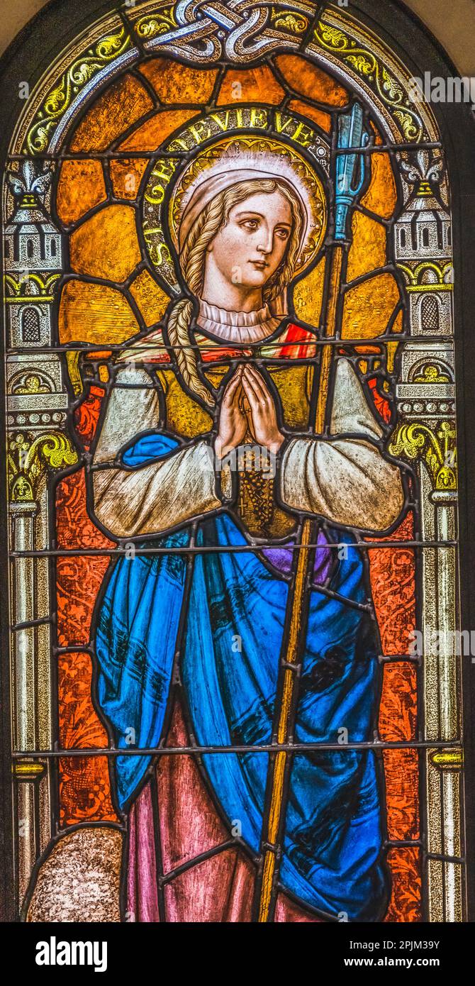 Saint Genevieve stained glass, Phoenix, Arizona. Genevieve Patron Saint of Paris, died 500 AD. Church rebuilt stained glass 1915 Stock Photo