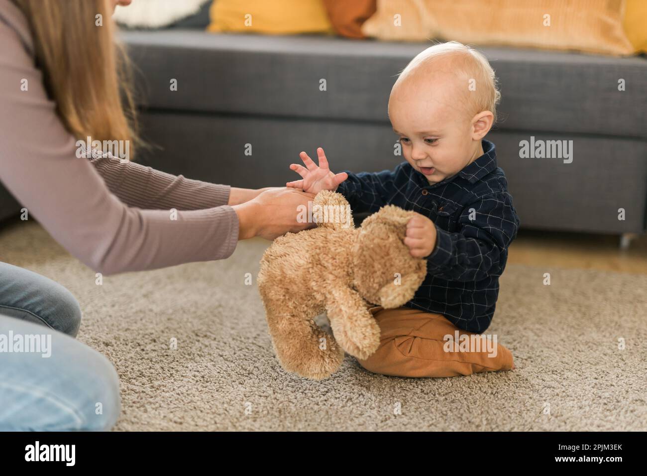 Teddy Playing Child playing with teddy bear. Little boy hugging his favorite toy at ...