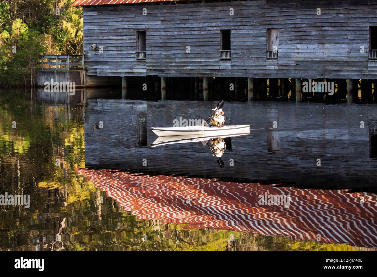 USA, Twin City. Kayaker at grist mill at Smith State