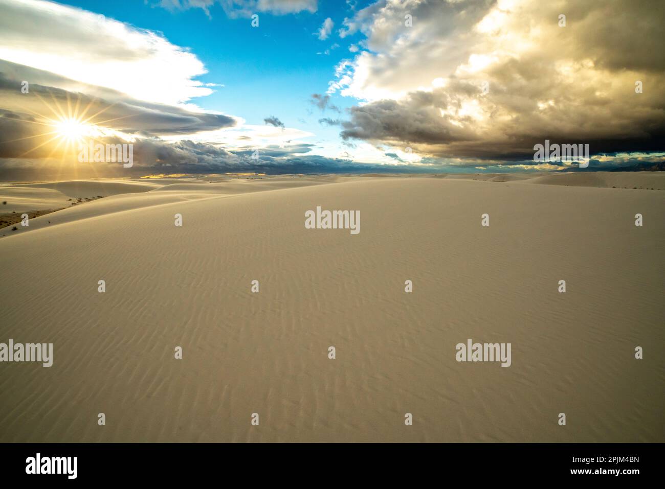USA, New Mexico, White Sands National Monument. Sunrise clouds over white desert sand. Stock Photo