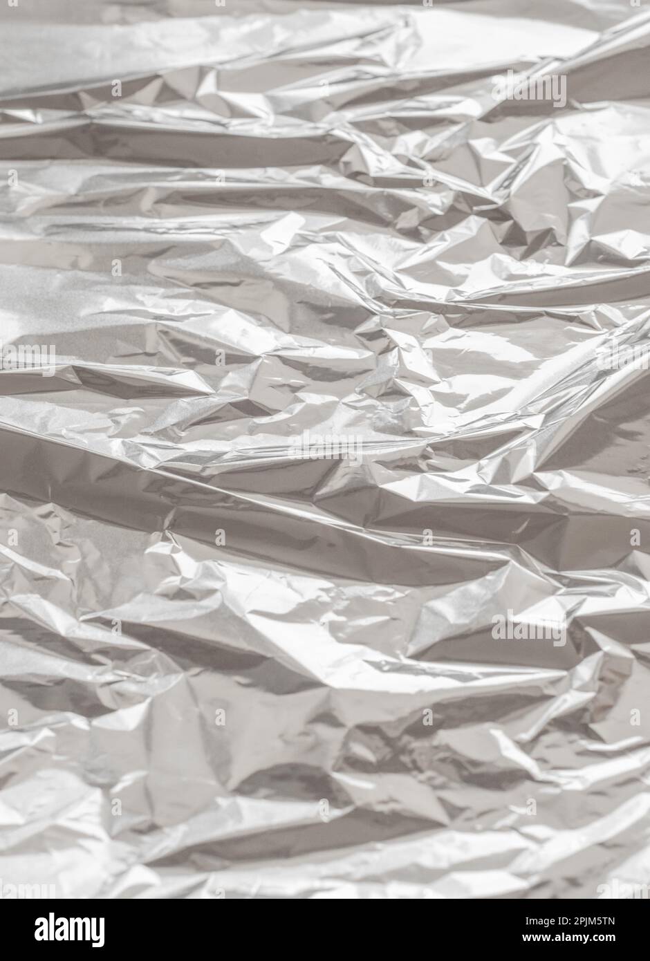 Metallic foil texture. Metallic background. Metal glittering, crushed, glister surface, backdrop. Crumpled texture. Reflective surface. Folded, rumple Stock Photo