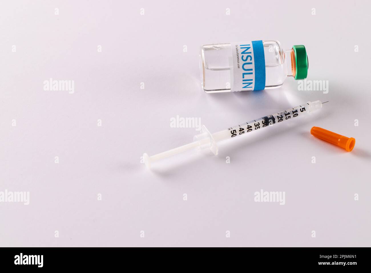 Insulin vial and uncapped syringe on white background with copy space Stock Photo