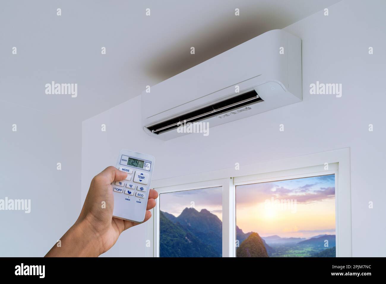 Man turning on the air conditioner Stock Photo Alamy